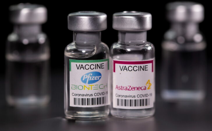 FILE PHOTO: Picture illustration of vials with Pfizer-BioNTech and AstraZeneca coronavirus disease (COVID-19) vaccine labels
