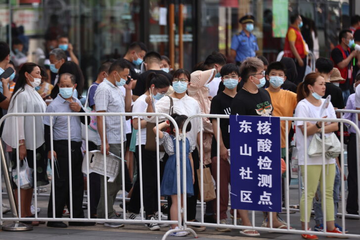 People line up at a makeshift nucleic acid testing site in Nanjing