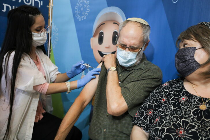A man receives his third dose of the coronavirus disease (COVID-19) vaccine at a Clalit healthcare maintenance organisation in Jerusalem