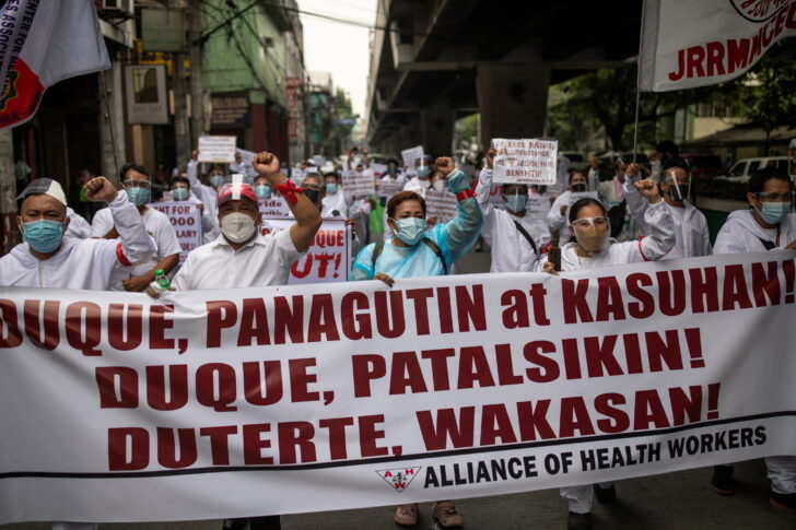 Healthcare workers protest outside the Department of Health in Manilla