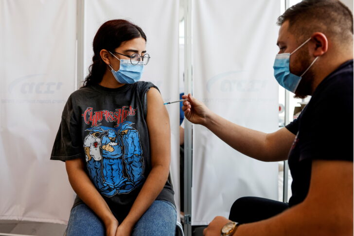 FILE PHOTO: An Israeli woman receives a third shot of coronavirus disease (COVID-19) vaccine in Tel Aviv