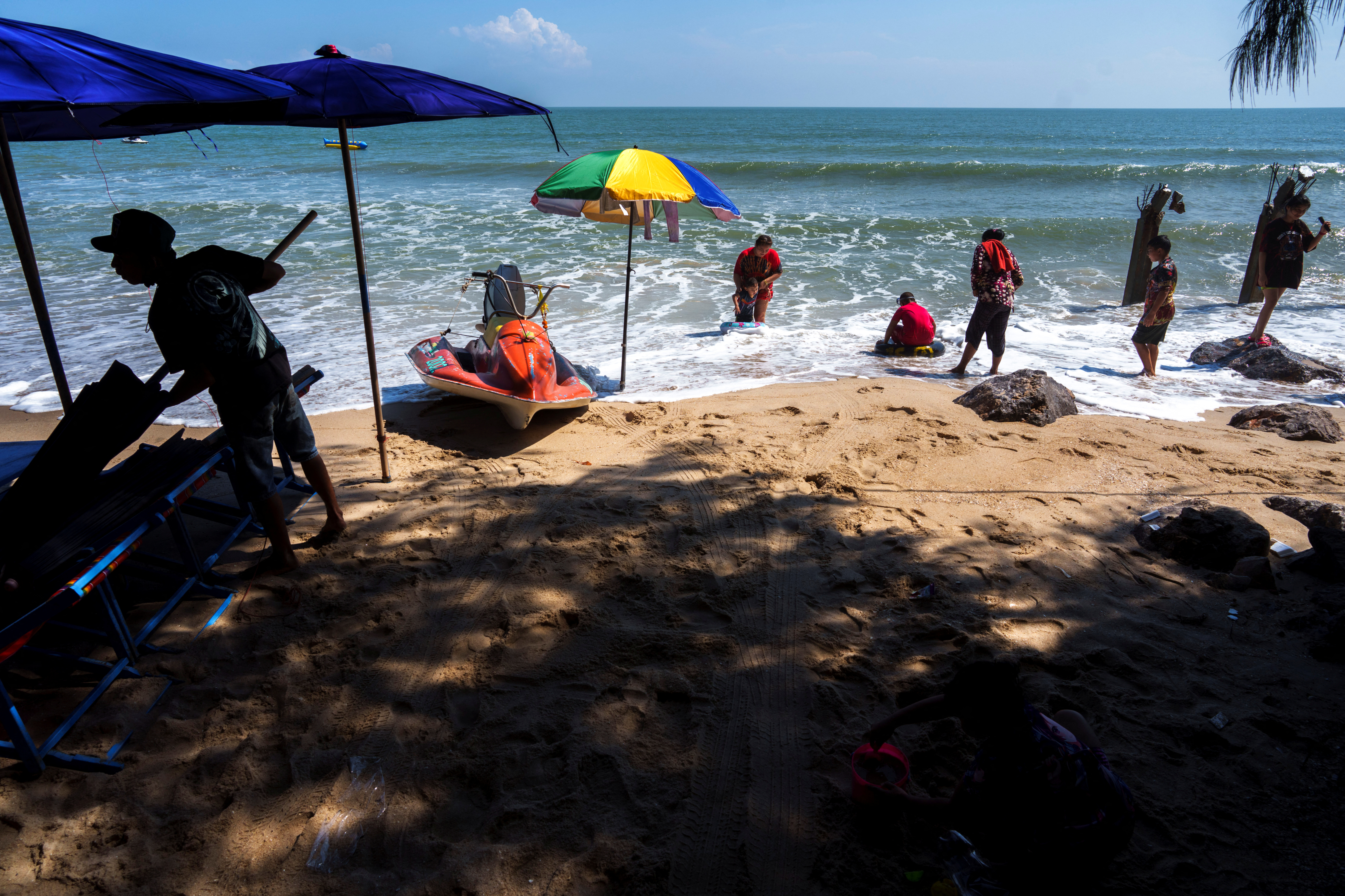 People enjoy at Cha-am Beach, amid the coranavirus disease (COVID-19) outbreak, in Phetchaburi province