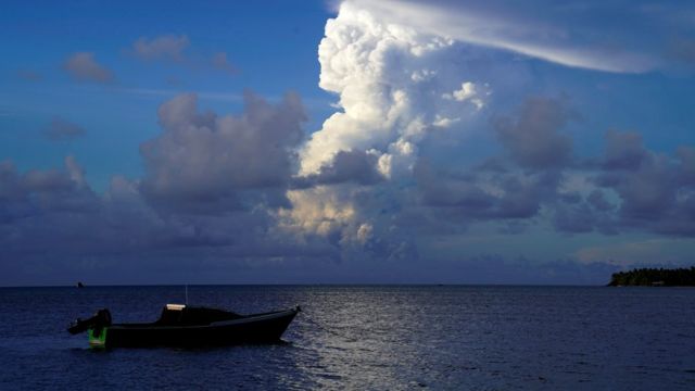 This picture taken on December 21, 2021 shows white gaseous clouds rising from the Hunga Ha'apai eruption seen from the Patangata coastline near Tongan capital Nuku'alofa