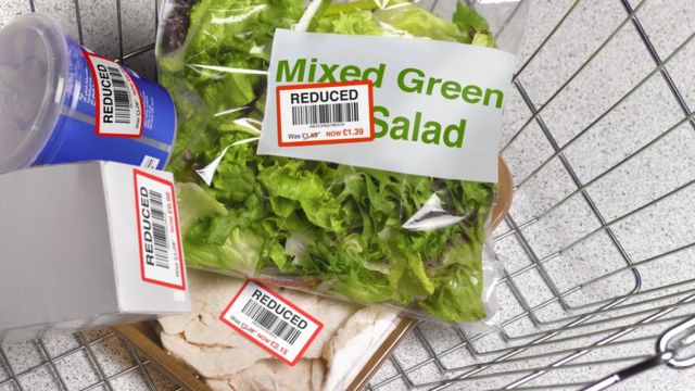 Picture of a shopping basket full of groceries with reduced stickers