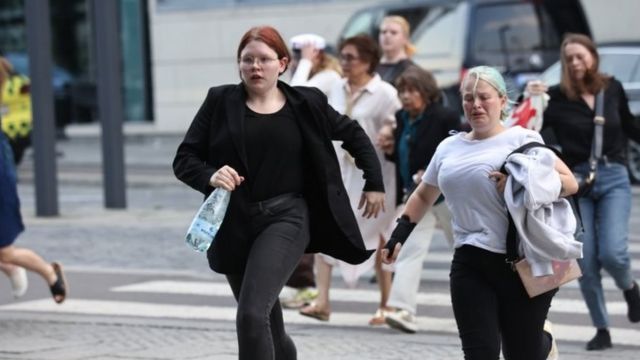 People run from the Fields shopping centre following a shooting, 3 July