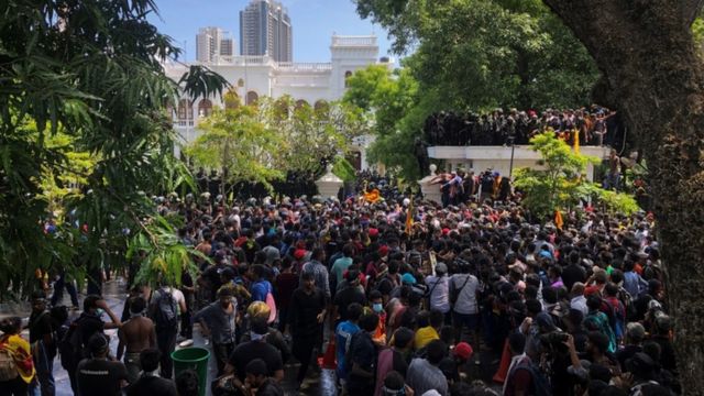 Demonstrators gather outside the office of Sri Lanka's prime minister in Colombo, Sri Lanka
