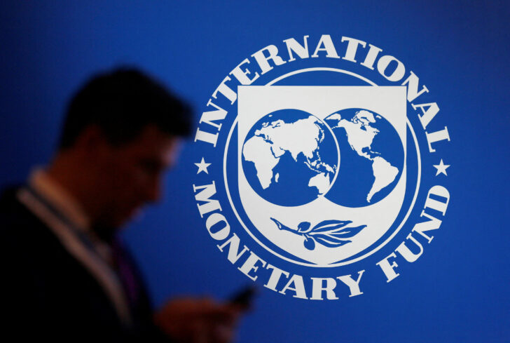 FILE PHOTO: A participant stands near a logo of IMF at the International Monetary Fund - World Bank Annual Meeting 2018 in Nusa Dua IMF หั่นคาดการณ์เศรษฐกิจ หวั่นโลกเข้าสู่ภาวะถดถอย