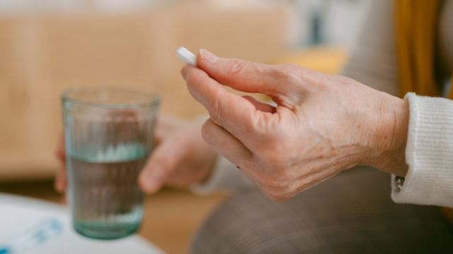 hand holding tablet with water