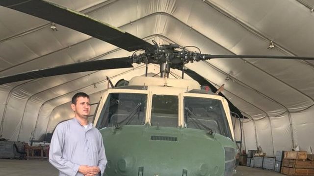 Momand in front of his helicopter