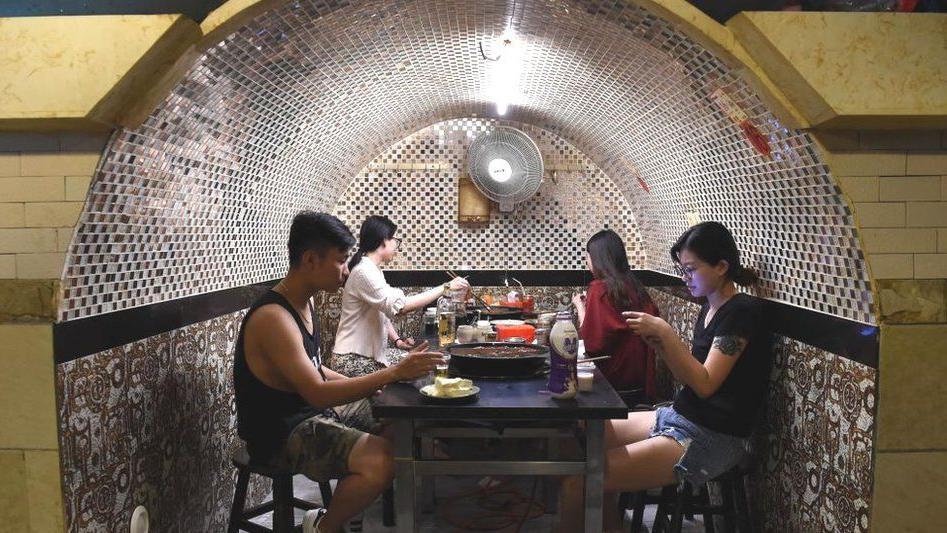 ชาวจีนหลบร้อน กินชาบูหม้อไฟใต้ดินและในถ้ำ