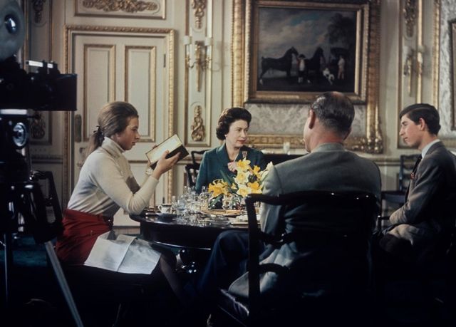 Queen Elizabeth II lunches with Prince Philip and their children Princess Anne and Prince Charles at Windsor Castle in Berkshire, circa 1969. A camera (left) is set up to film for Richard Cawston's BBC documentary 'Royal Family', which followed the Royal Family over a period of a year and was broadcast on 21st June 1969.