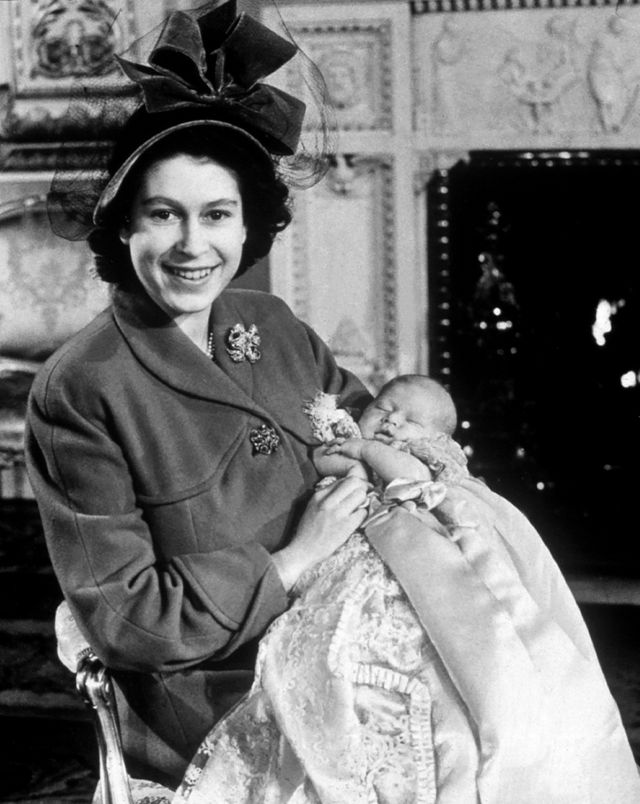 Her Majesty Queen Elizabeth II, pictured when she was Princess Elizabeth, with her first baby (now King Charles III) at his christening in 1948