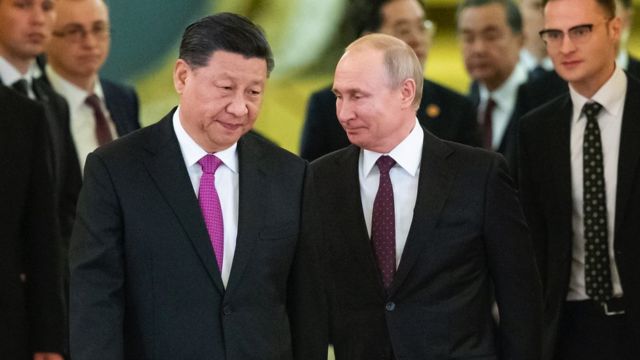 Russian President Vladimir Putin and his Chinese counterpart Xi Jinping enter a hall for the talks at the Kremlin in Moscow on June 5, 2019.