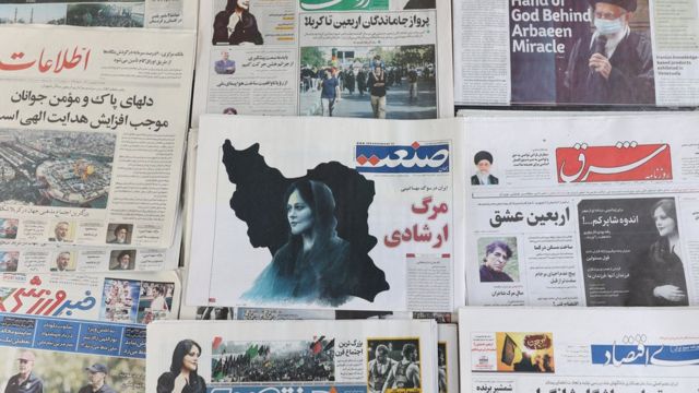 Iranian newspapers on sale in Tehran show photographs of Mahsa Amini on 18 September 2022