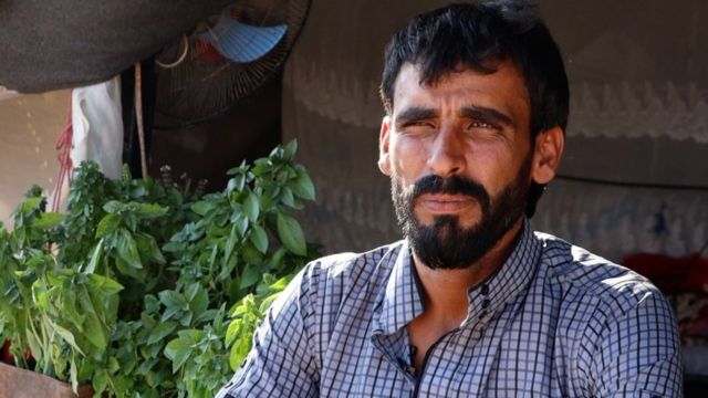 Hamid, with a dark beard and checked shirt