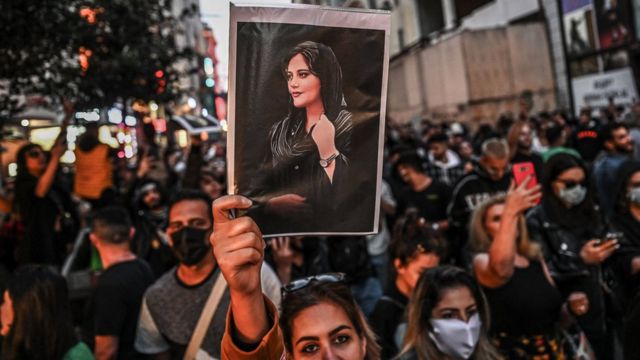 A protester holds a portrait of Mahsa Amini during a demonstration in Istanbul on 20 September 2022