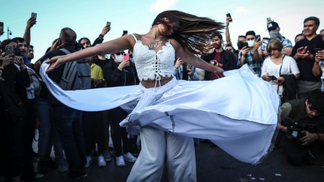An Iranian female activist performs as people shout slogans during a protest following the death of Iranian Mahsa Amini, in Istanbul, Turkey, 02 October 2022