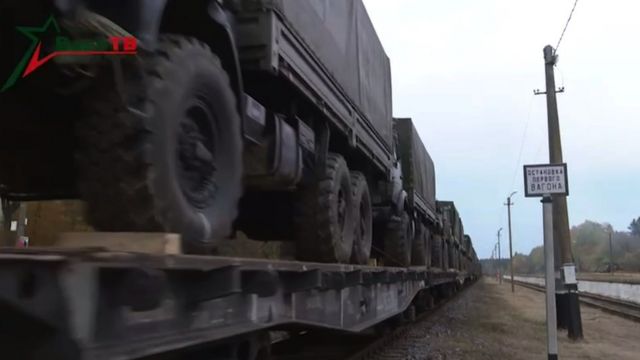 Railway platform with military equipment