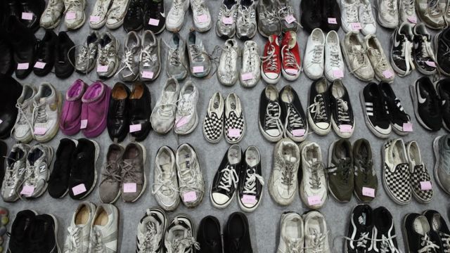 Image of dozens of shoes from victims of Seoul Stampede.