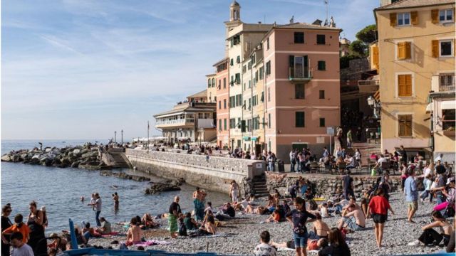 People enjoying a warm Sunday in the fisherman village of Boccadesse, in the outskirt of Genova, Italy.