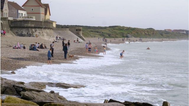 People enjoy the seaside during a warm afternoon on October 29, 2022 in Audresselles, France