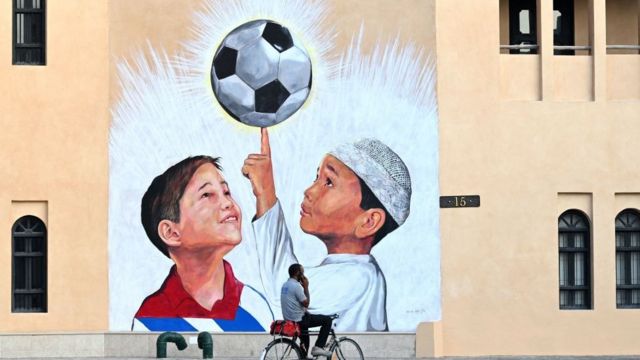 A mural of children and a football in Qatar