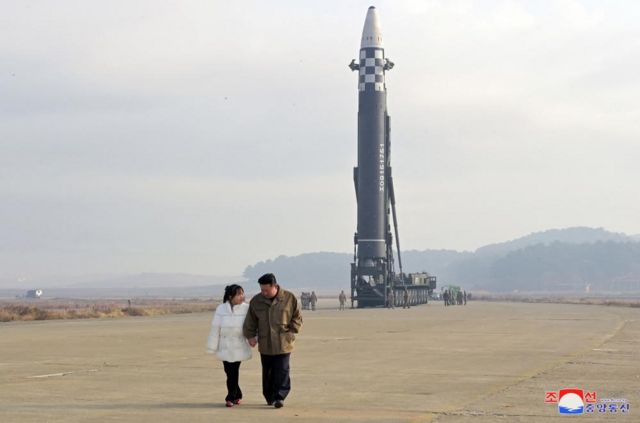 North Korea's leader Kim Jong-un is seen standing hand-in-hand with his daughter in this photo released by KCNA news agency