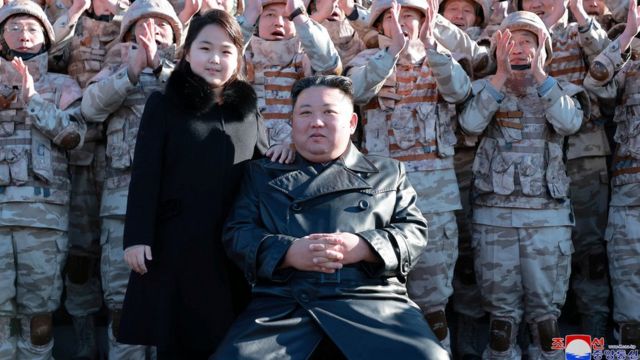 North Korean leader Kim Jong Un and his daughter attend a photo session with the scientists, engineers, military officials and others involved in the test-fire of the country's new Hwasong-17 intercontinental ballistic missile