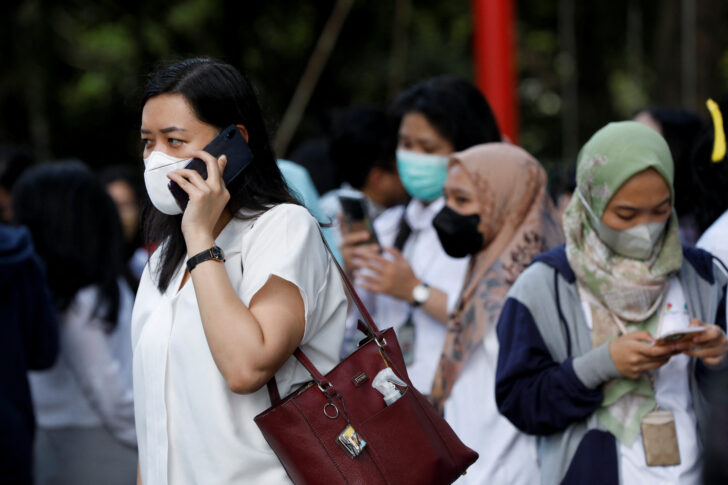 People gather as they are evacuated outside a building following an earthquake in Jakarta แผ่นดินไหวขนาด 5.6 ที่อินโดนีเซีย ตายอย่างน้อย 20