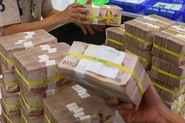 Bank employees gather Thai baht notes at a Kasikornbank in Bangkok เงินบาท-ธนบัตรไทย-banknote