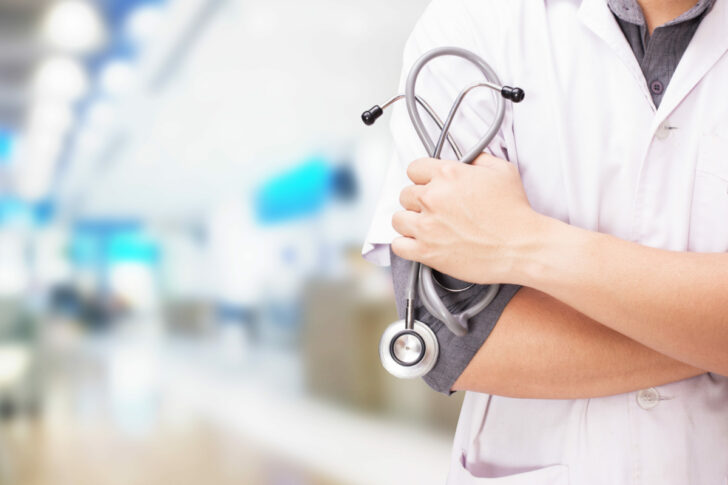 Doctor with a stethoscope in the hands and hospital background ธุรกิจการแพทย์