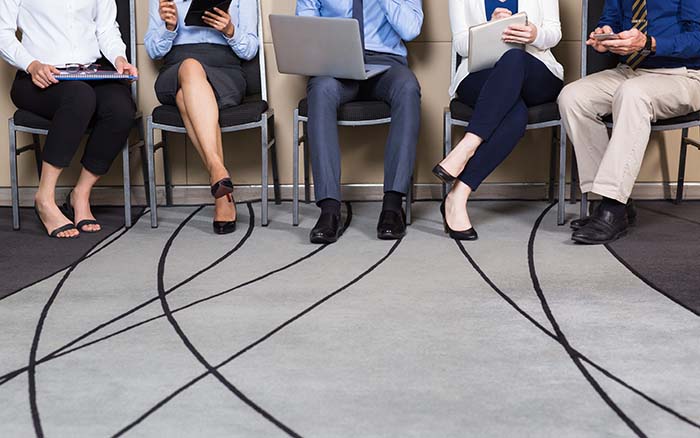 Cropped View of Business People Sitting in Row