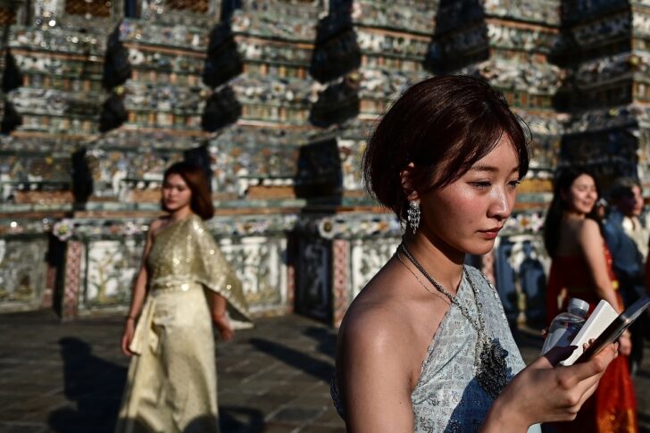 นักท่องเที่ยวแต่งชุดไทย ถ่ายภาพคู่กับพระปรางค์วัดอรุณฯ