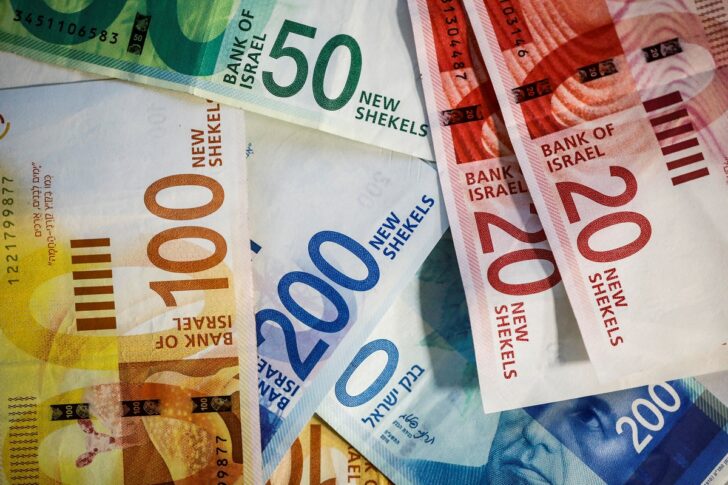 FILE PHOTO: New Israeli Shekel banknotes are seen in this picture illustration New Israeli Shekel banknotes-REUTERS FILE PHOTO