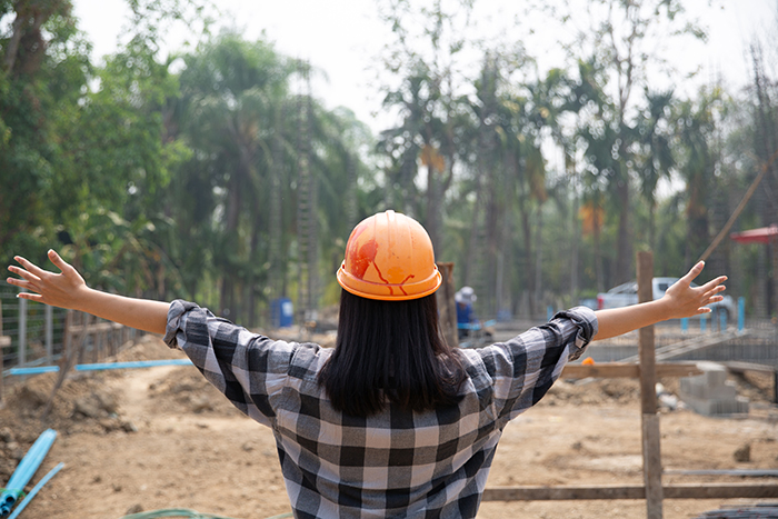 Happy construction worker and work. Portrait of satisfied brickl