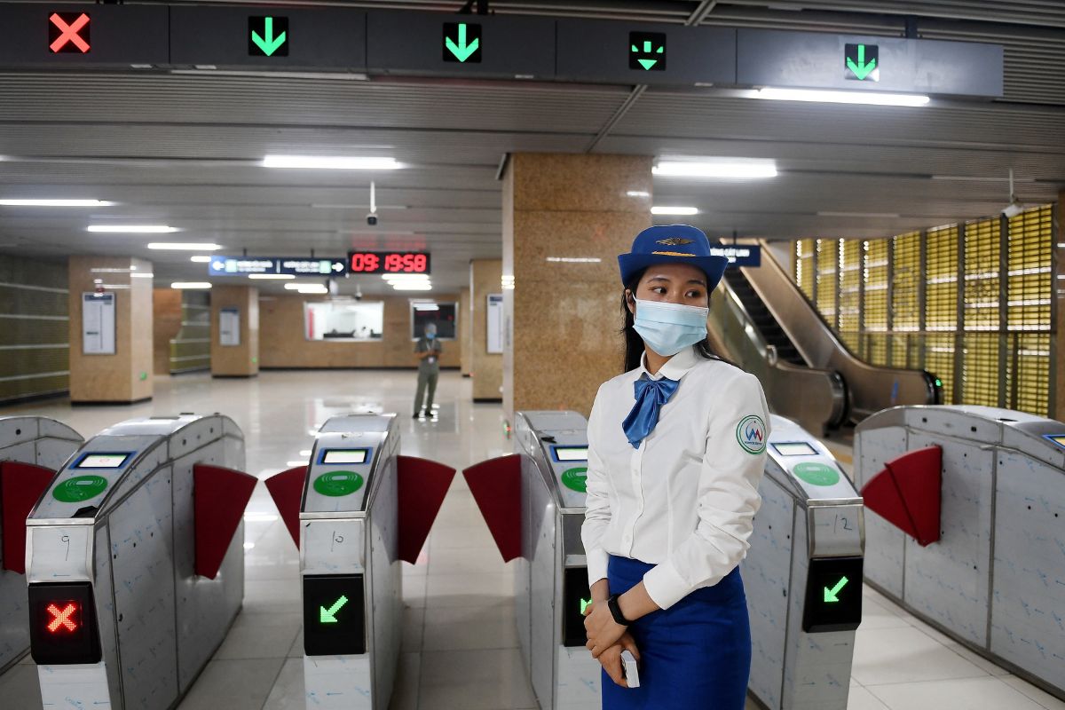 พนักงานยืนอยู่หน้าทางเข้าสถานีรถไฟฟ้าสายก๊าตลิญ-ฮาดง