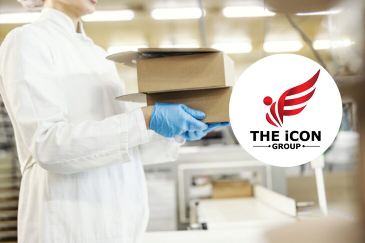 Cropped picture of female food factory worker's hands carry boxes with baking products.