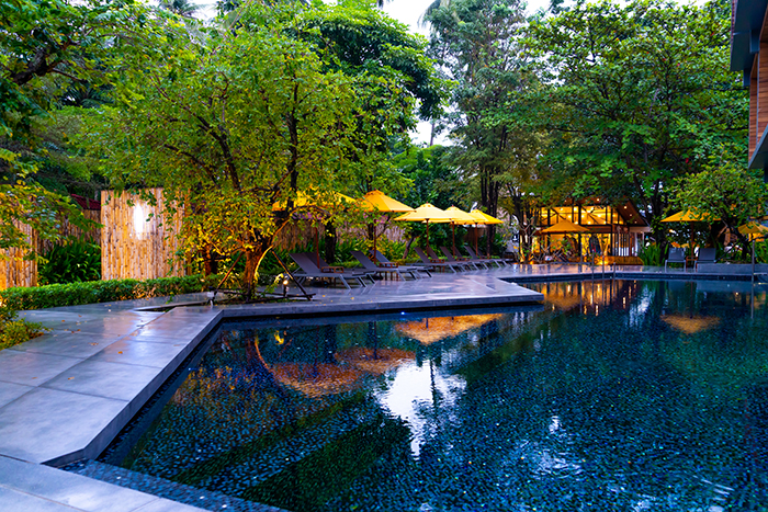 umbrella and pool bed around swimming pool