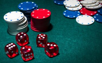 red-dices-stack-gambling-chips-green-poker-table
