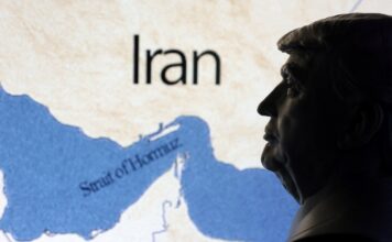 Illustration shows map showing the Strait of Hormuz, Iran and 3D printed miniature of U.S. president Donald Trump