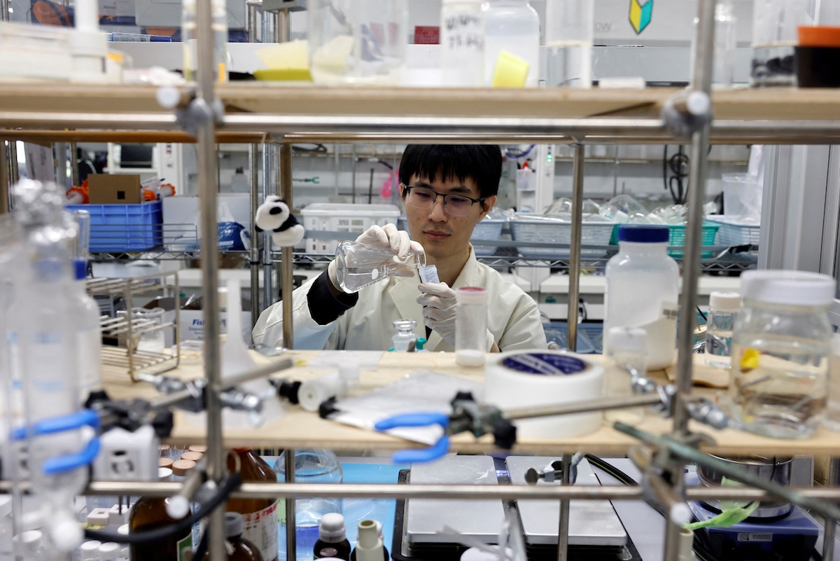 A researcher demonstrates the process of compounding the ocean-degradable plastic raw materials at the Center for Emergent Matter Science of Japanese research institution Riken in Wako