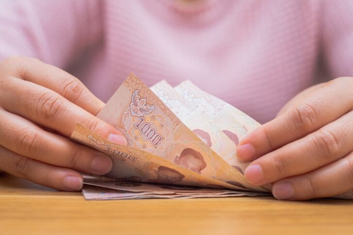 Close up of asian woman with calculator counting money.Woman calculate the spending at home. Close up of asian woman with calculator counting money.Woman calculate the spending at home.