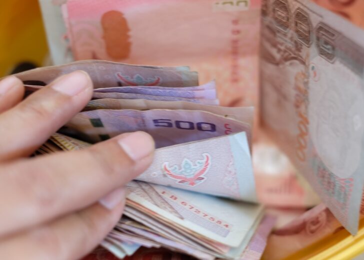 cropped-hand-touching-paper-currencies